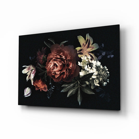 Dark glass wall art panel displaying red peony and white flowers with yellow lily against black background, angled three-quarter view.