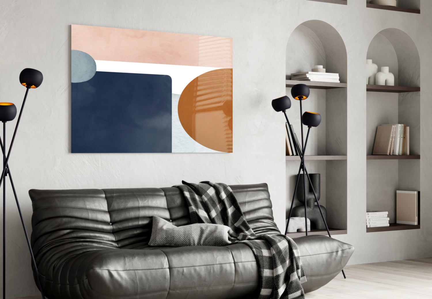 Modern living room interior featuring Copenhagen Glass Wall Art with navy, peach, and terracotta geometric shapes above black leather sofa.