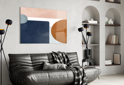 Modern living room interior featuring Copenhagen Glass Wall Art with navy, peach, and terracotta geometric shapes above black leather sofa.