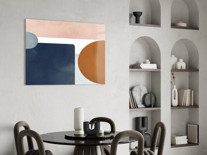 Modern dining room featuring abstract glass wall art with navy, terracotta, and blush geometric shapes above black round table.
