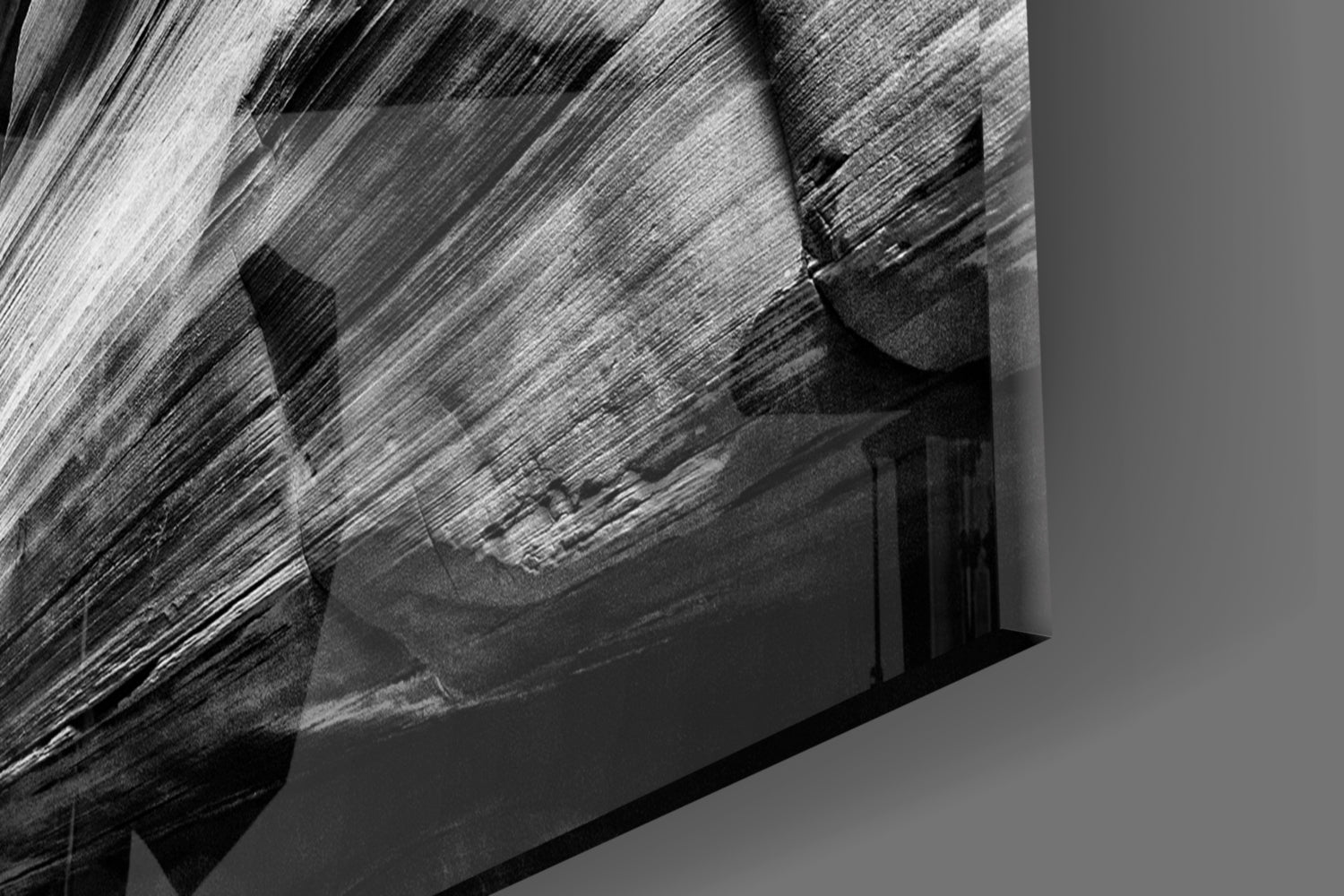 Close-up detail of textured black and white glass surface showing brushstroke patterns and layered depth against neutral background.