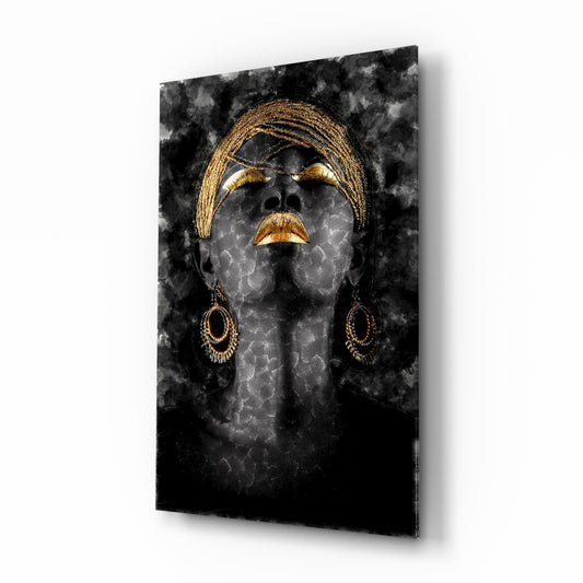 Black glass wall art displaying a woman's face with golden braids, closed eyes, and ornamental earrings against a textured dark background.