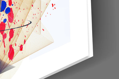 Close-up angled view of glass wall art with red and blue abstract patterns on cream mesh texture background.