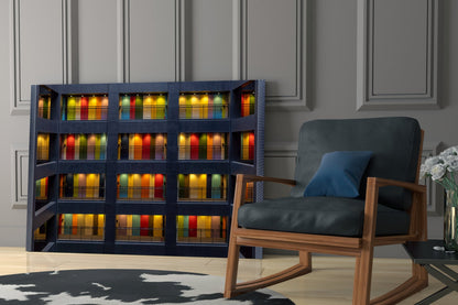 Modern living room interior displaying colorful glass wall art depicting illuminated apartment building facade with mid-century wooden chair.