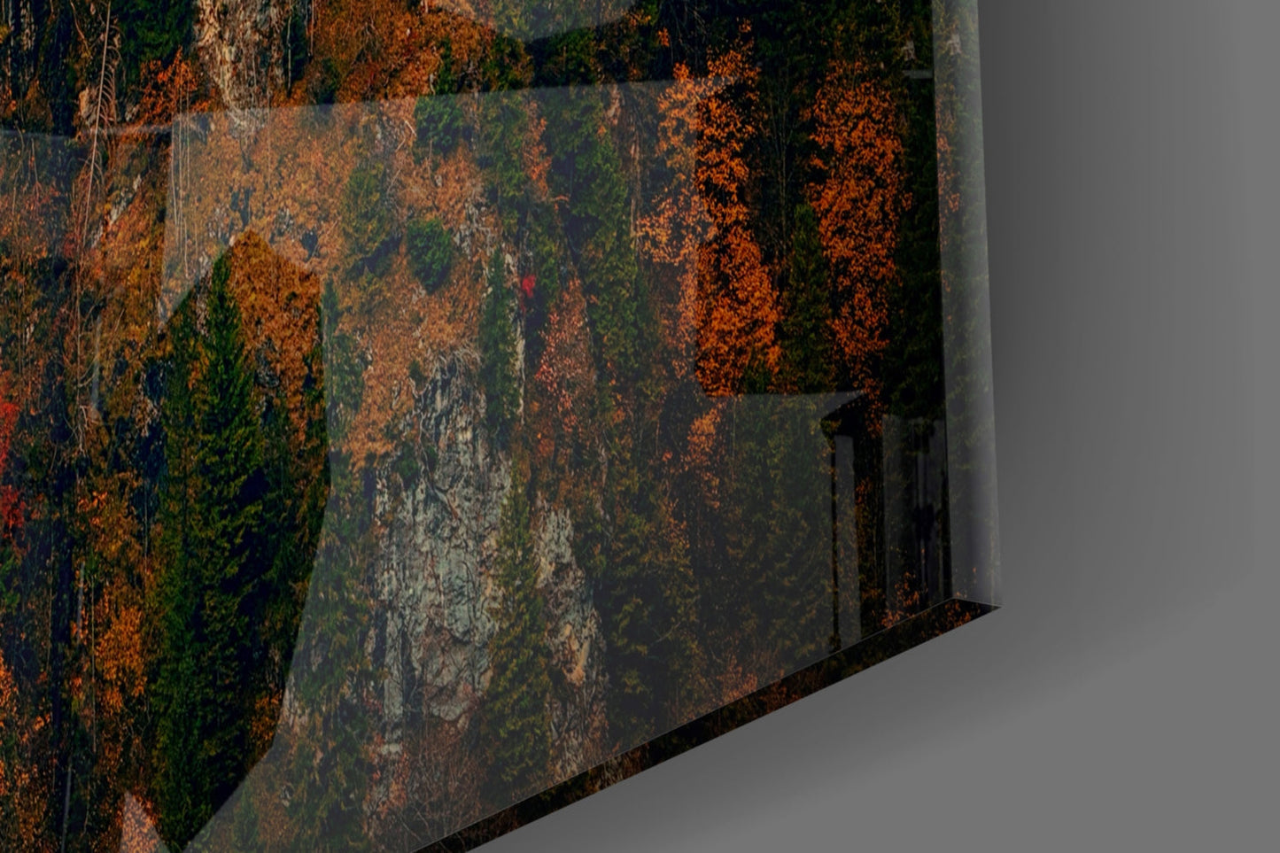 Close-up detail of glass wall art showing rust-orange, green, and grey patina texture with weathered metal surface finish.