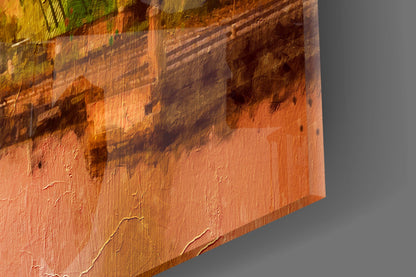 Close-up detail of textured glass surface showing warm orange and brown tones with shadowed relief patterns and brushstroke-like markings.
