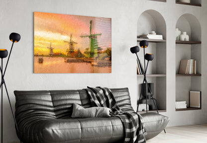 Windmills glass wall art depicting golden sunset over sailboats, displayed above black leather sofa in modern living room.