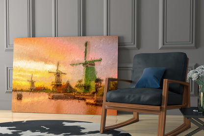 Windmills glass wall art depicting golden sunset over Dutch windmills displayed beside mid-century wooden chair in modern interior.