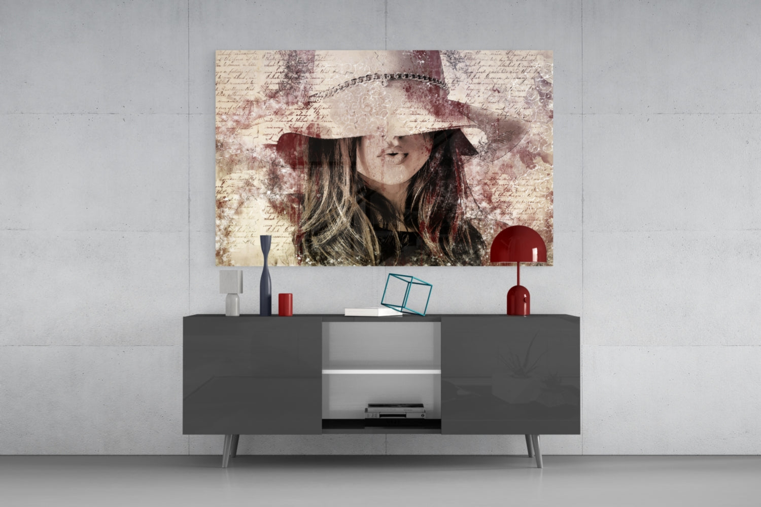 Vintage-style glass wall art of a woman wearing a wide-brimmed hat displayed above a dark gray media console with decorative accessories.