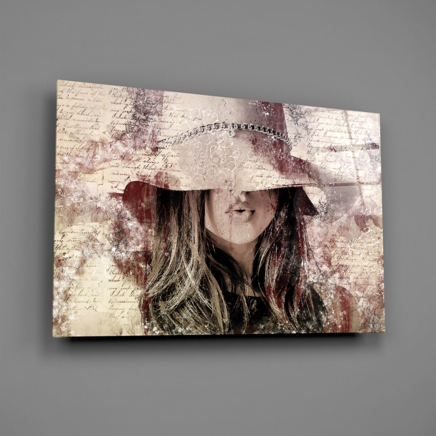 Glass wall art displaying a vintage-style portrait of a woman wearing a wide-brimmed hat with chain detail, overlaid on sepia-toned handwritten text and distressed background elements.