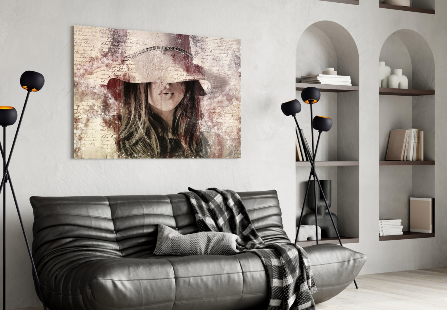 Vintage-style glass wall art depicting a woman in a decorative hat displayed above a black leather sofa in a modern living room.