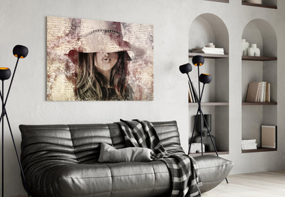 Vintage-style glass wall art depicting a woman in a decorative hat displayed above a black leather sofa in a modern living room.