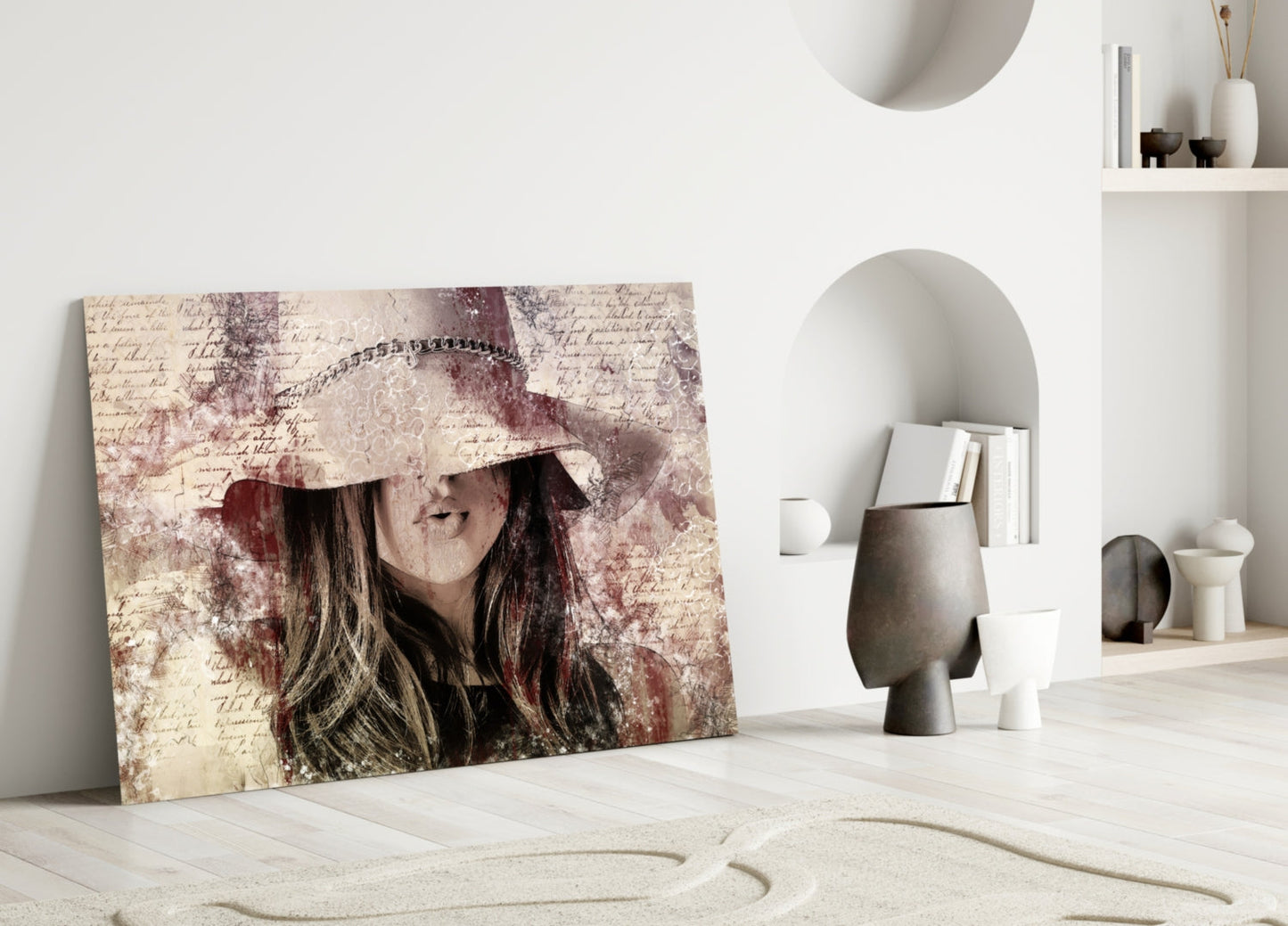 Vintage-styled glass wall art of a woman in a decorative hat leaning against a beige wall with handwritten text and burgundy distressing, displayed in a minimalist interior setting.