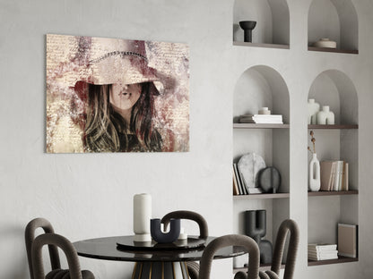 Vintage-style glass wall art featuring a woman in a wide-brimmed hat with sepia tones and handwritten text, displayed above a black dining table in a modern interior.