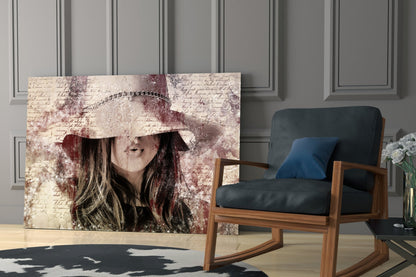 Glass wall art displaying a woman wearing a decorative hat with vintage lettering background, displayed in a modern living room setting.