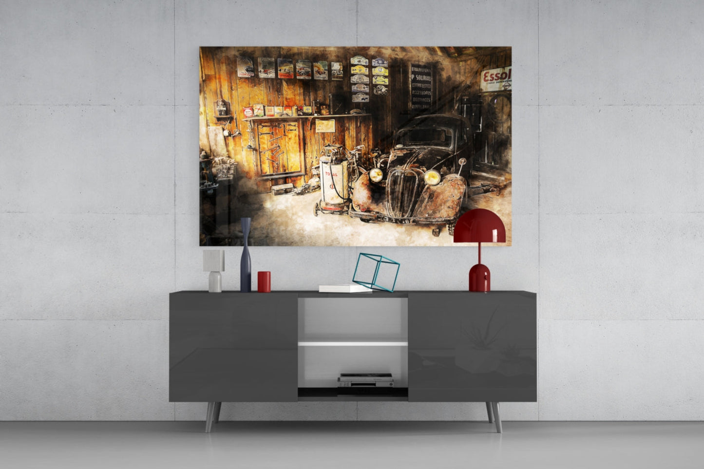 Retro garage glass wall art displaying a rusty vintage car and workshop interior, mounted above a dark gray media console in a modern living room setting.