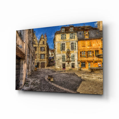 Medieval square glass wall art displayed at an angle, showing a European stone plaza with half-timbered and yellow buildings beneath blue sky.
