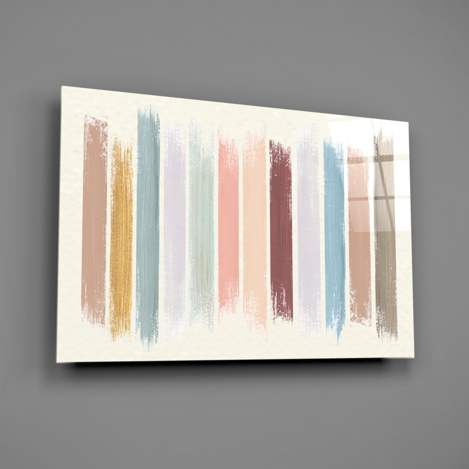 Horizontal glass wall art displaying vertical brushstrokes in muted pastels including mauve, teal, rose, burgundy, and gold on cream background, mounted on gray wall.