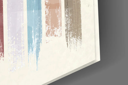 Angled perspective of glass wall art displaying vertical painted strokes in mauve, teal, coral, and gray on cream background.