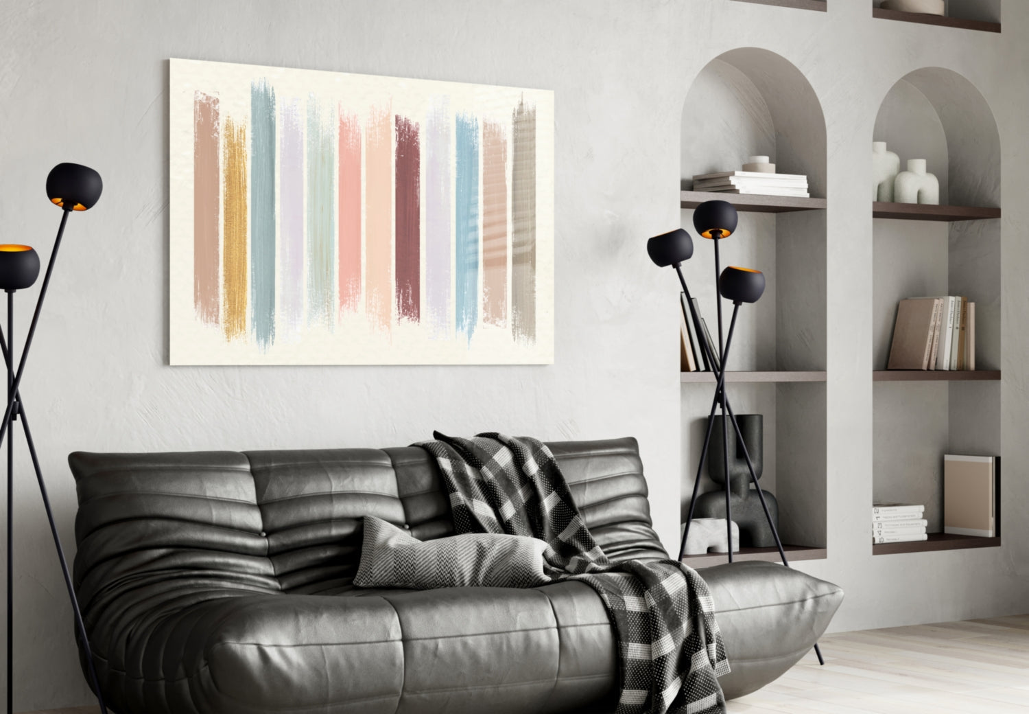 Horizontal glass wall art with vertical pastel brush strokes in muted tones displayed above a black leather sofa in a modern living room.