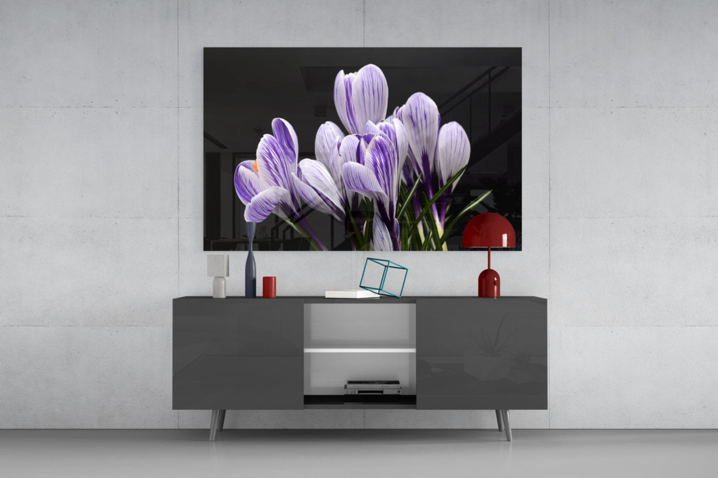 Purple and white striped crocus flowers displayed on glass wall art above a gray media console in a modern living room setting.