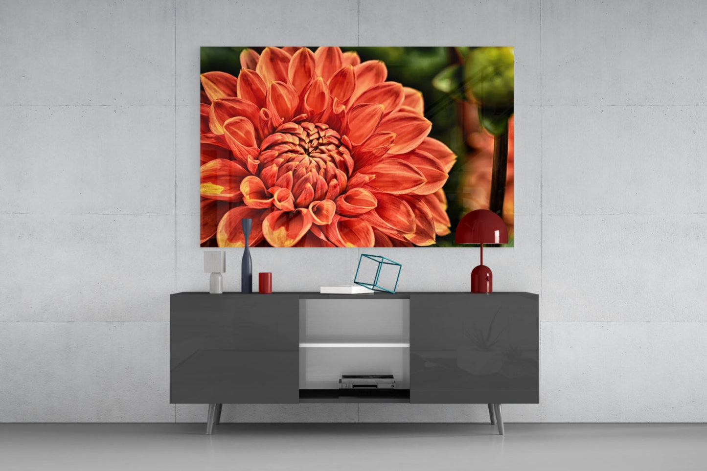 Orange gerbera flower glass wall art displayed above gray media console in modern living room interior.