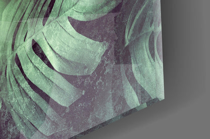 Close-up detail of layered tropical leaf glass art showing textured green and purple tones with dimensional relief.