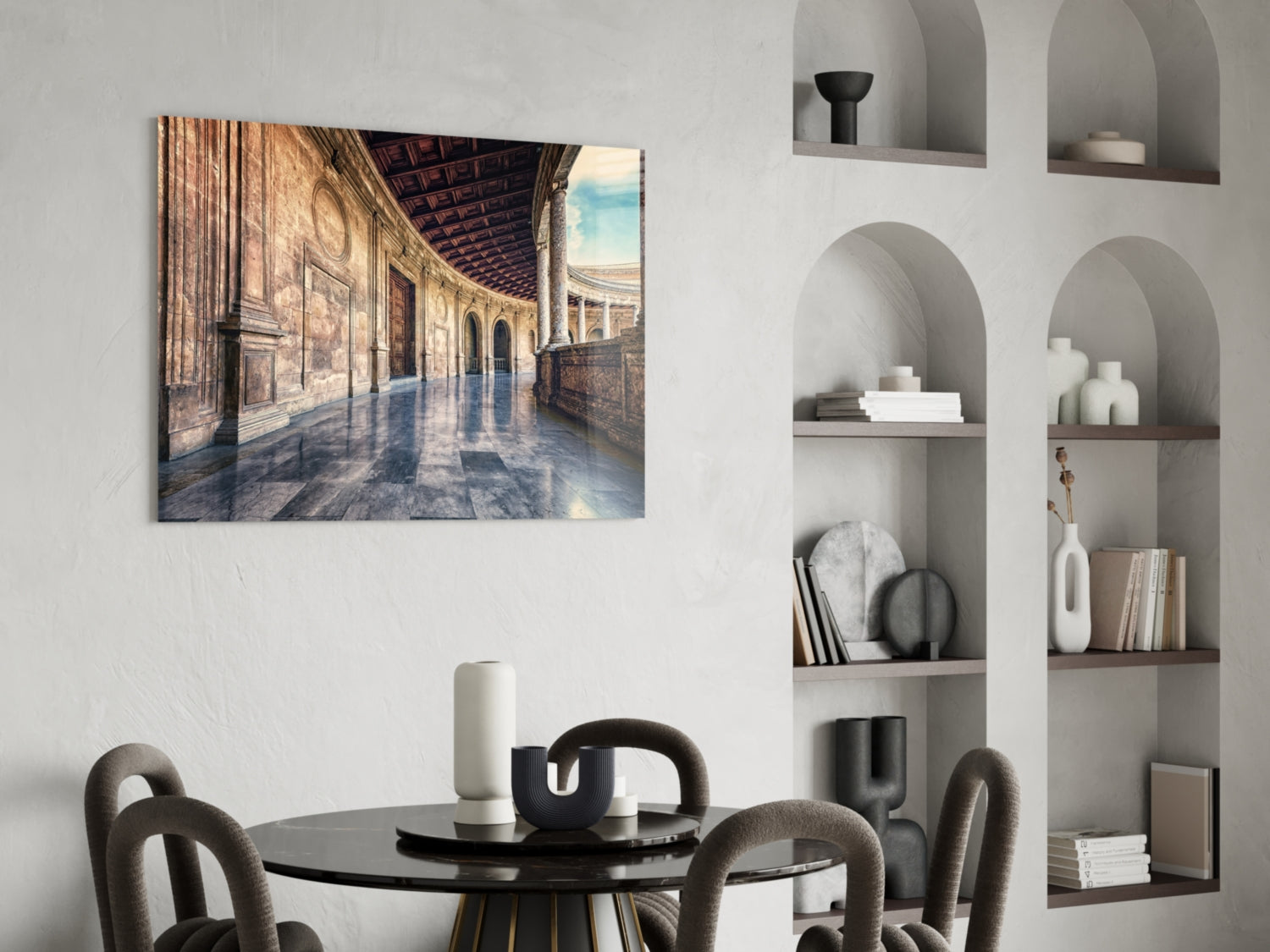 Glass wall art depicting a sunlit baroque colonnade with arched ceiling and checkered floor displayed above a dining table.