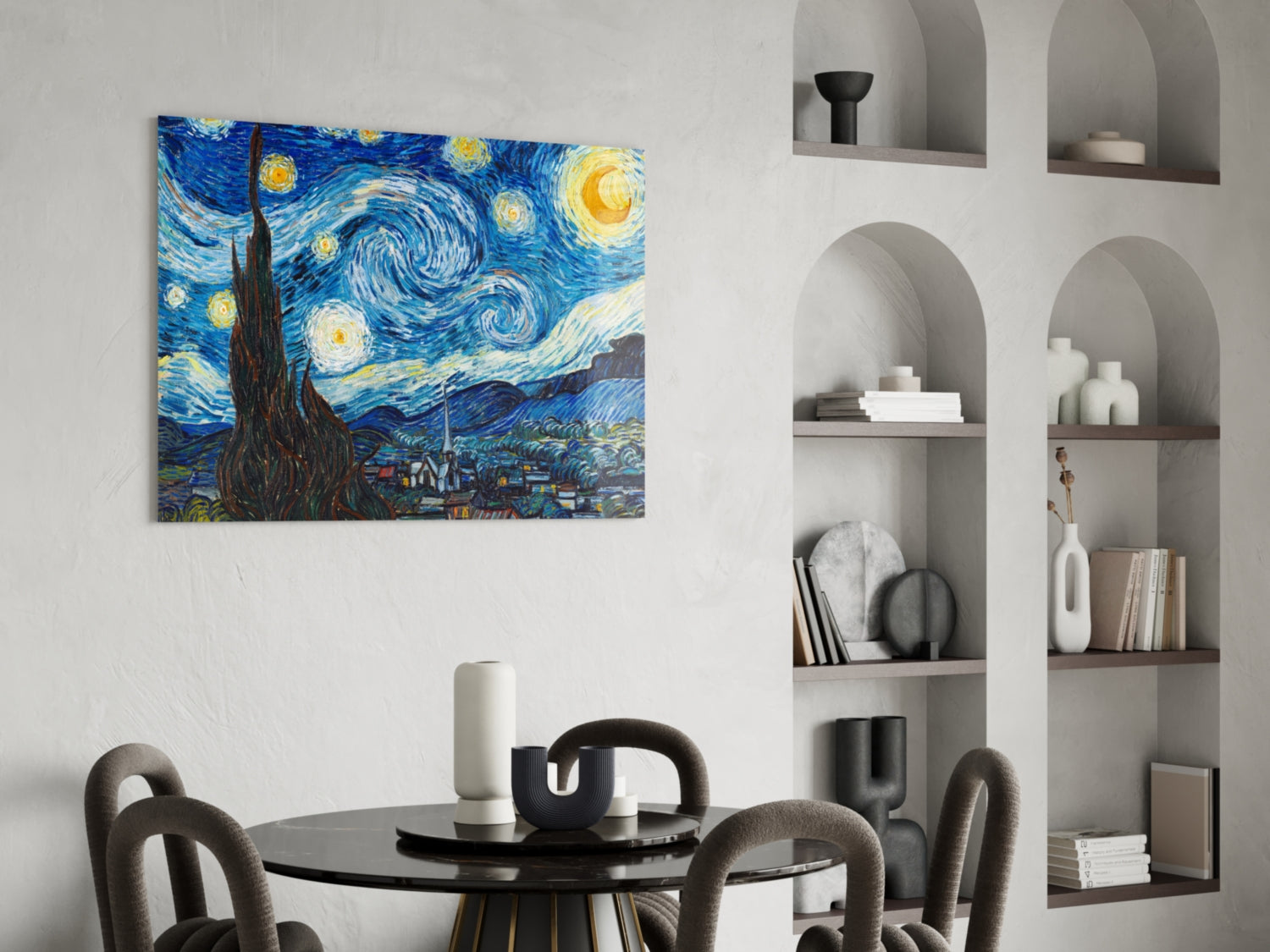 Van Gogh Starry Night glass wall art hanging above a black round dining table with gray chairs in a modern interior with built-in shelving.