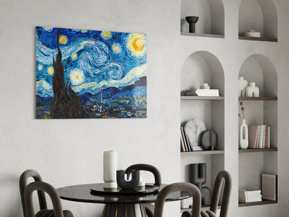 Van Gogh Starry Night glass wall art hanging above a black round dining table with gray chairs in a modern interior with built-in shelving.