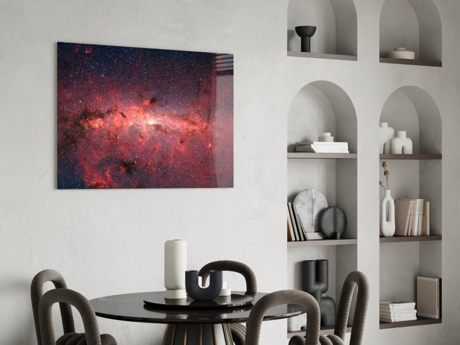 Red Nebula Glass Wall Art displaying a cosmic scene with red and pink star fields hung above a black dining table with grey chairs.