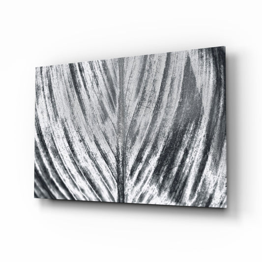 Silver Brushed Leaf Glass Wall Art displayed at an angle, showing radiating streaked texture in monochromatic grays and whites.