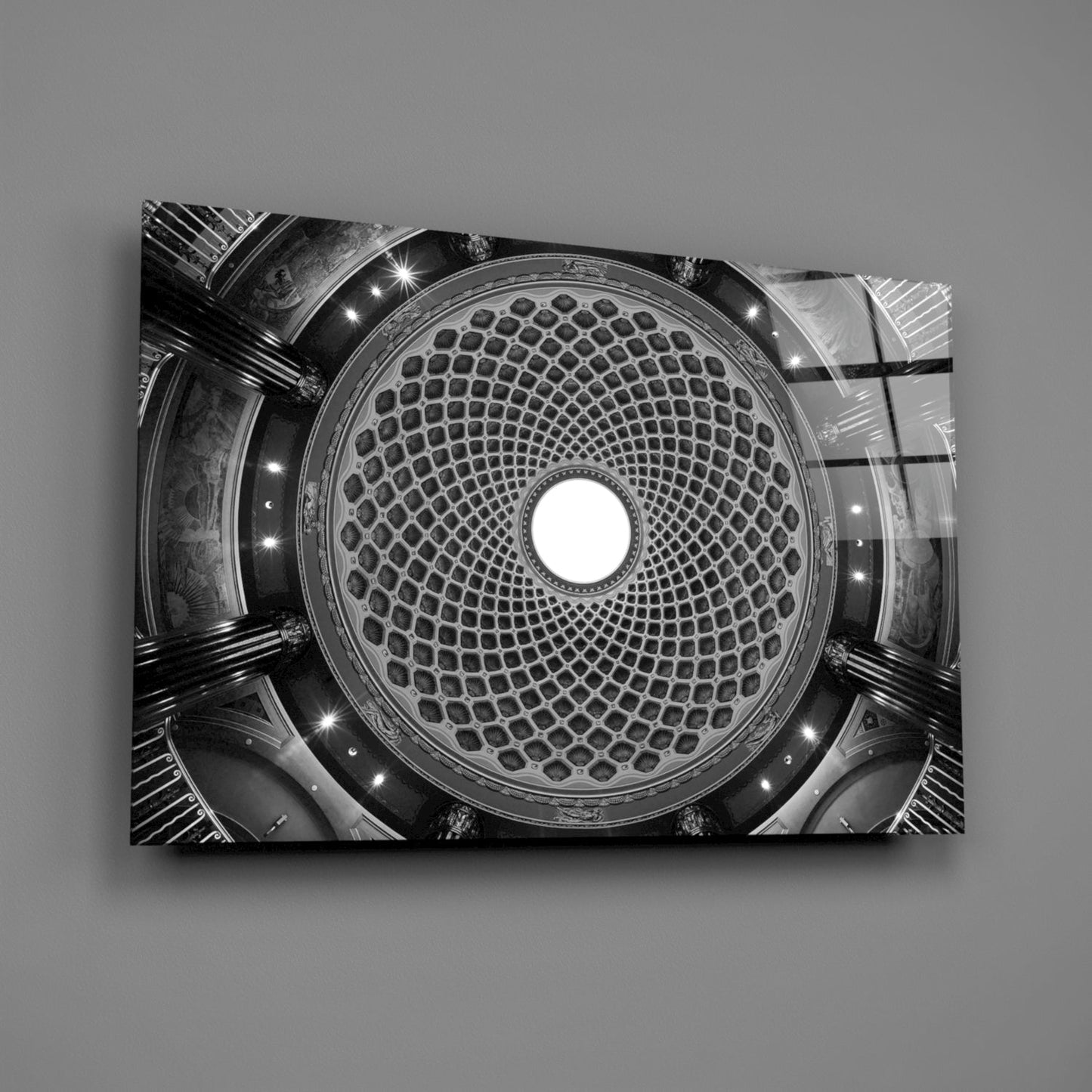 Black and white upward view of an ornate domed ceiling with geometric lattice pattern and central skylight opening.