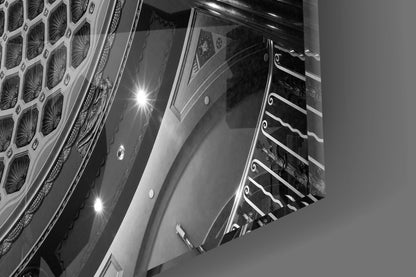 Upward view of ornate dome ceiling with shell pattern detailing, recessed lighting, and decorative architectural molding in black and white.