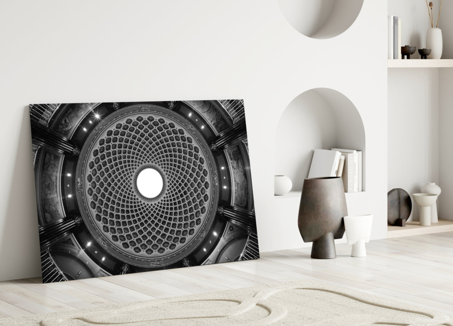 Black and white architectural dome glass art leaning against white wall in minimalist interior setting.