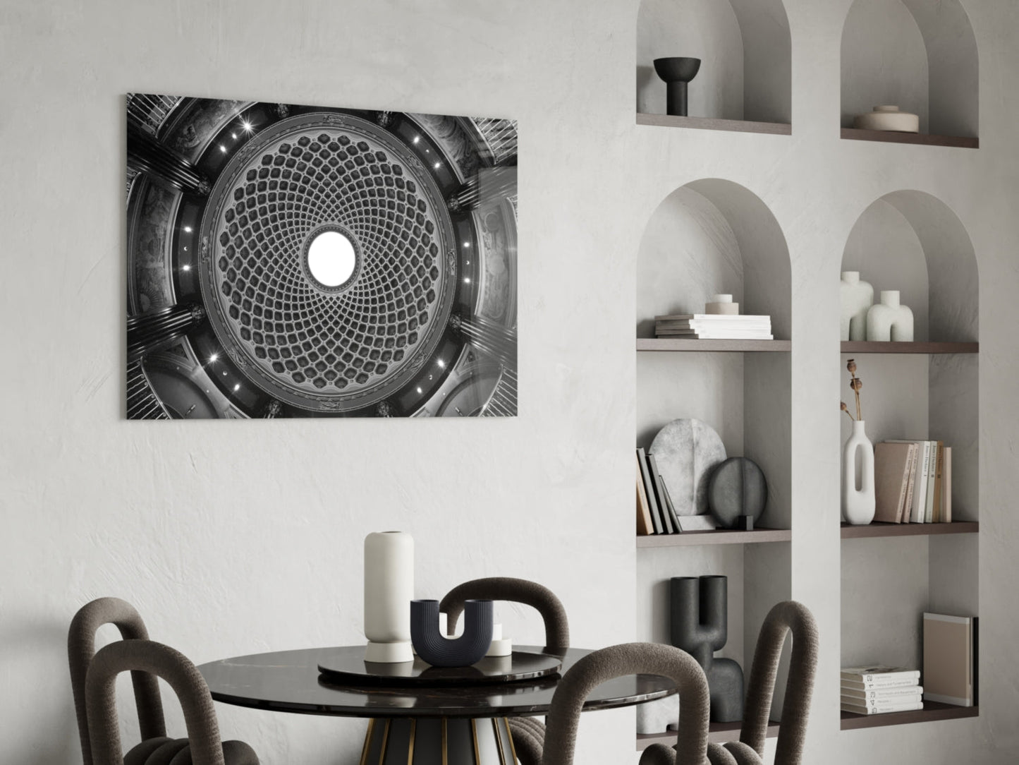 Black and white photograph of geometric dome ceiling with concentric circular grid pattern and central light, displayed above dining table in modern interior.