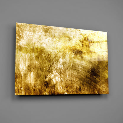 Gold and cream abstract textured glass panel mounted on gray wall, angled perspective view.