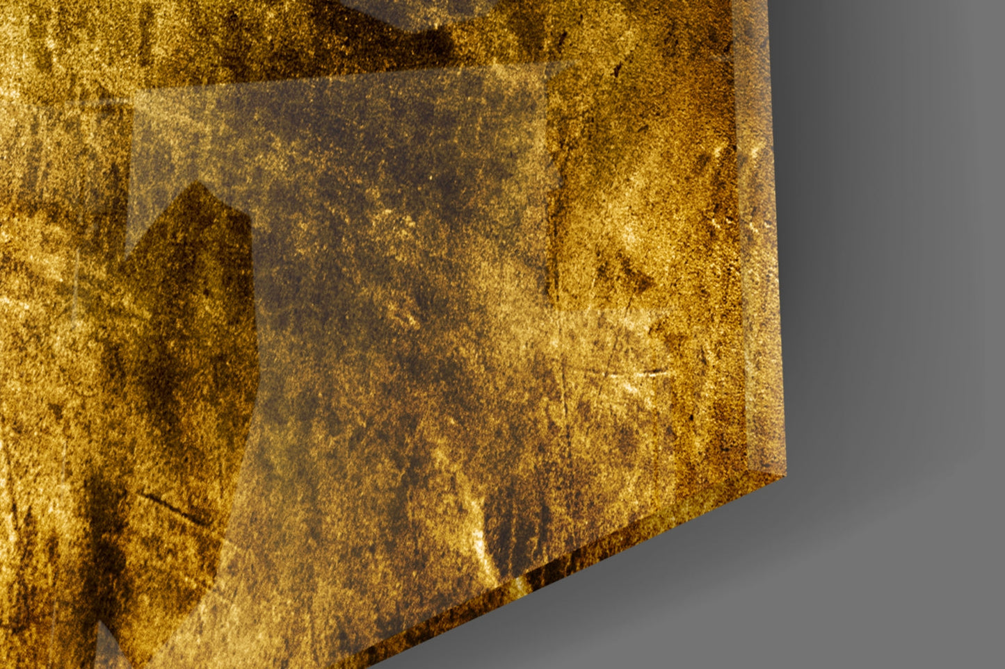Close-up detail of yellow and gold textured glass surface with mottled patina and subtle depth variations against gray background.
