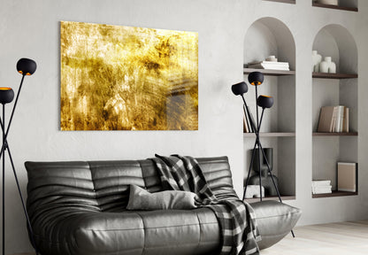 Yellow abstract textured glass art panel mounted above black leather sofa in modern living room with shelving.