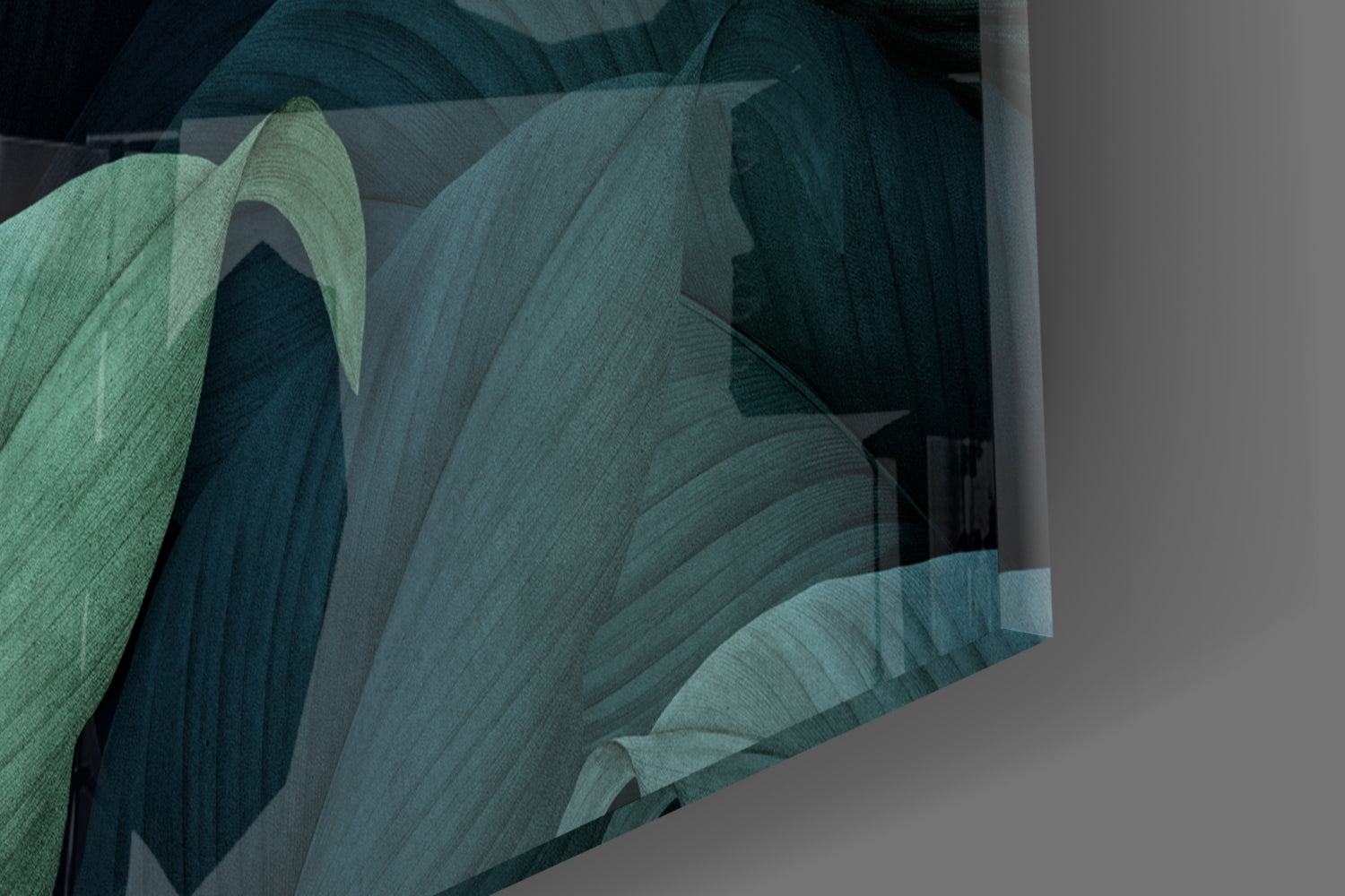 Close-up of layered green and teal glass sheets showing textured leaf forms and overlapping translucent planes against neutral background.