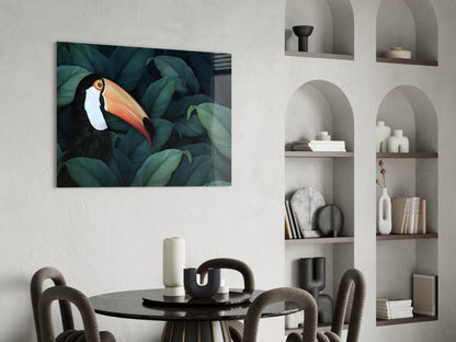 Toucan glass wall art with vibrant bird and teal foliage displayed above a dining table in a minimalist interior.
