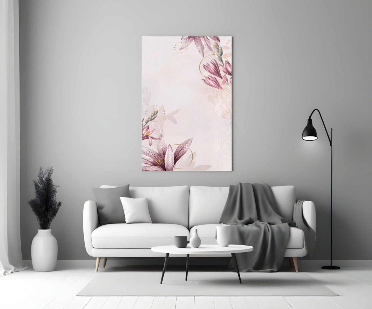 Pink floral glass wall art displayed above a white sofa in a minimalist living room with gray accents.