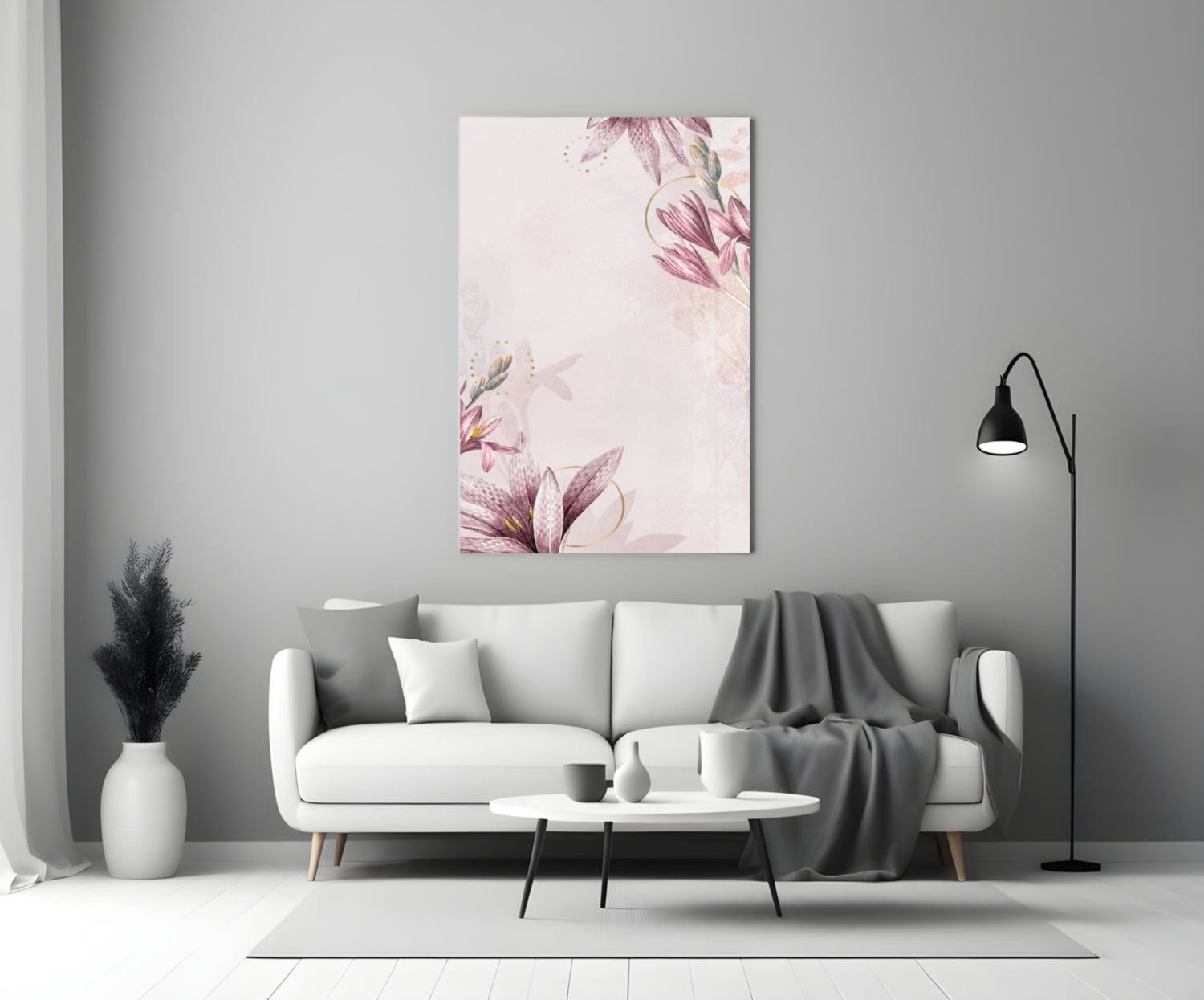 Pink floral glass wall art displayed above a white sofa in a minimalist living room with gray accents.
