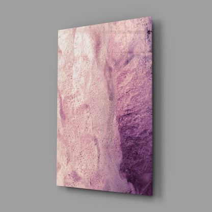 Pink abstract pattern glass wall art displayed at an angle against gray background, showing textured gradient from pale pink to deep purple.