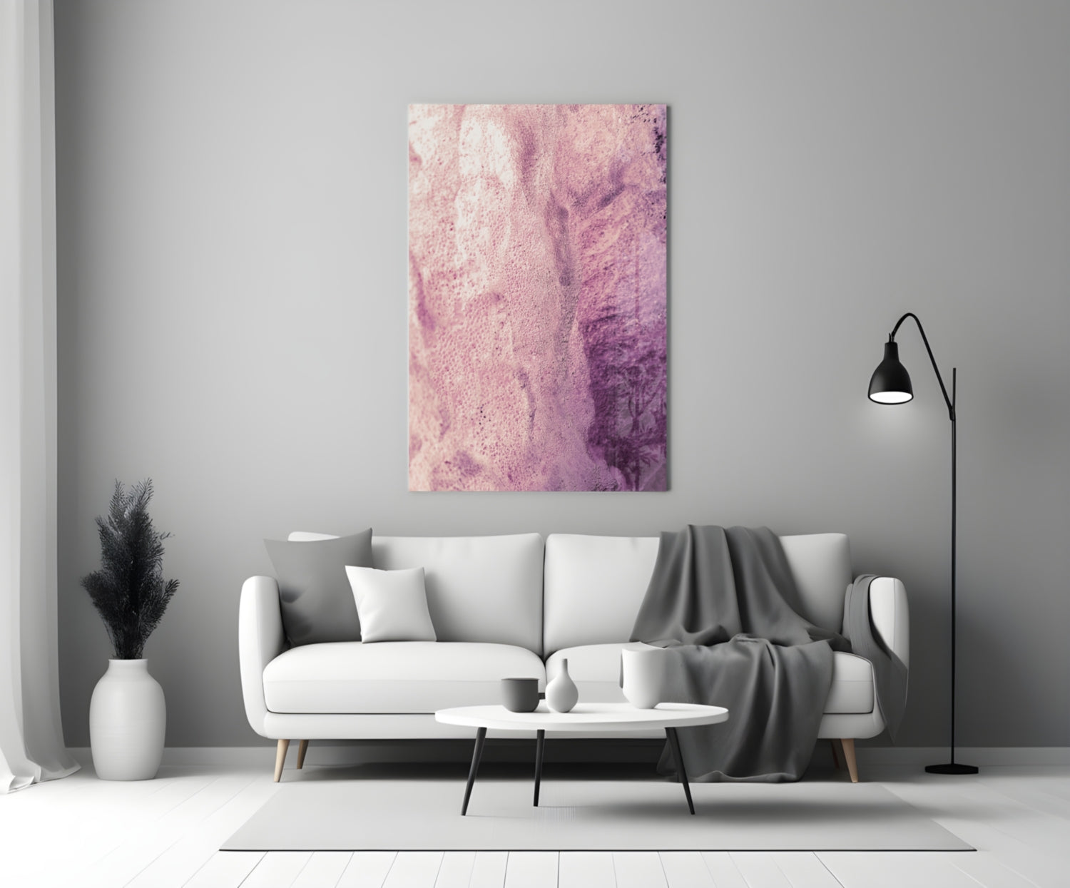 Pink abstract glass wall art with gradient watercolor effect displayed above white sofa in modern living room interior.