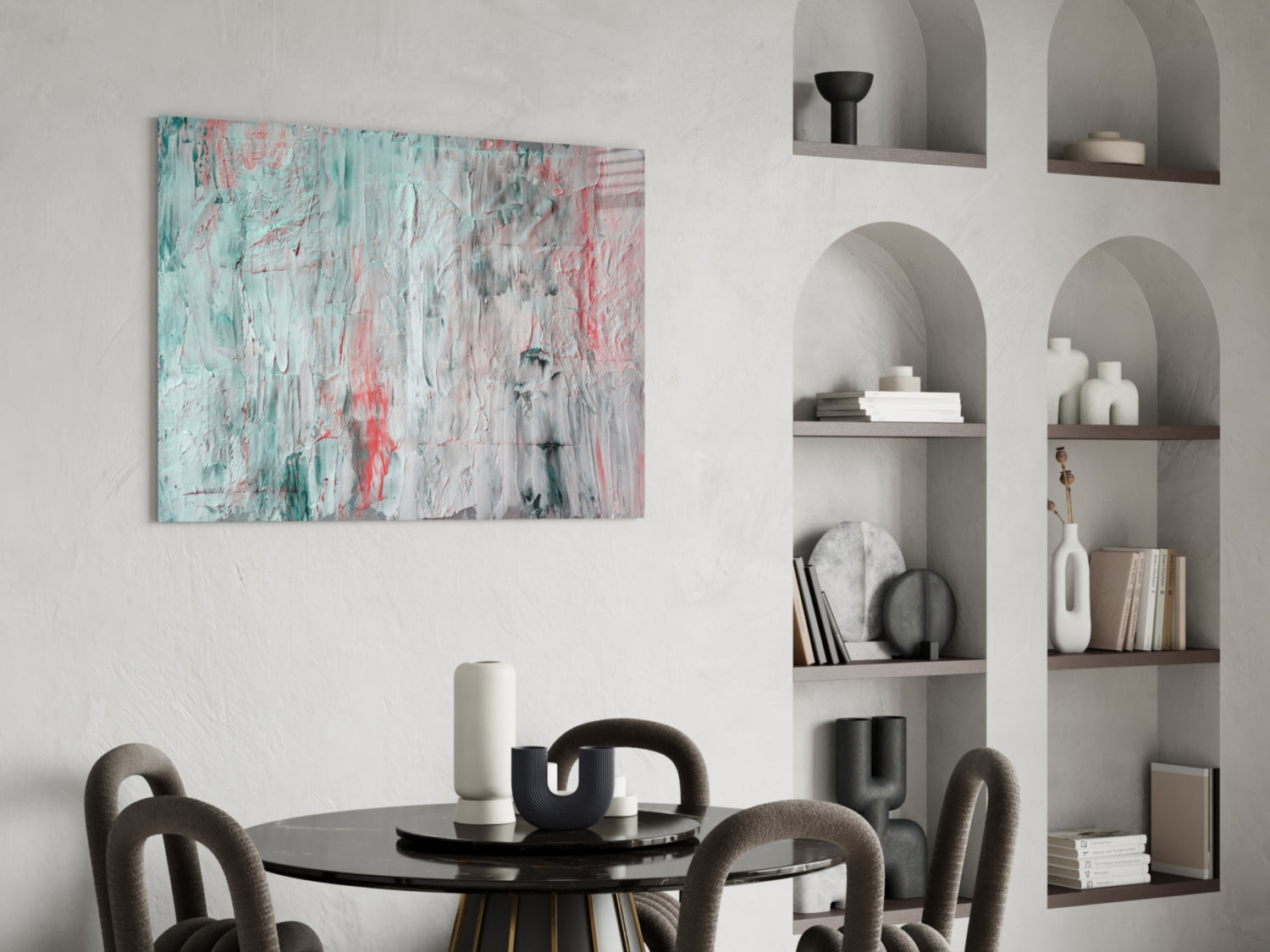 Abstract glass wall art with turquoise, pink, and white brushstrokes displayed above a round dining table with chairs.