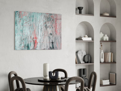 Abstract glass wall art with turquoise, pink, and white brushstrokes displayed above a round dining table with chairs.