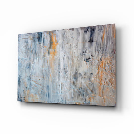 Abstract glass wall art displaying white, gray, and orange brushstroke textures mounted at an angle against white background.