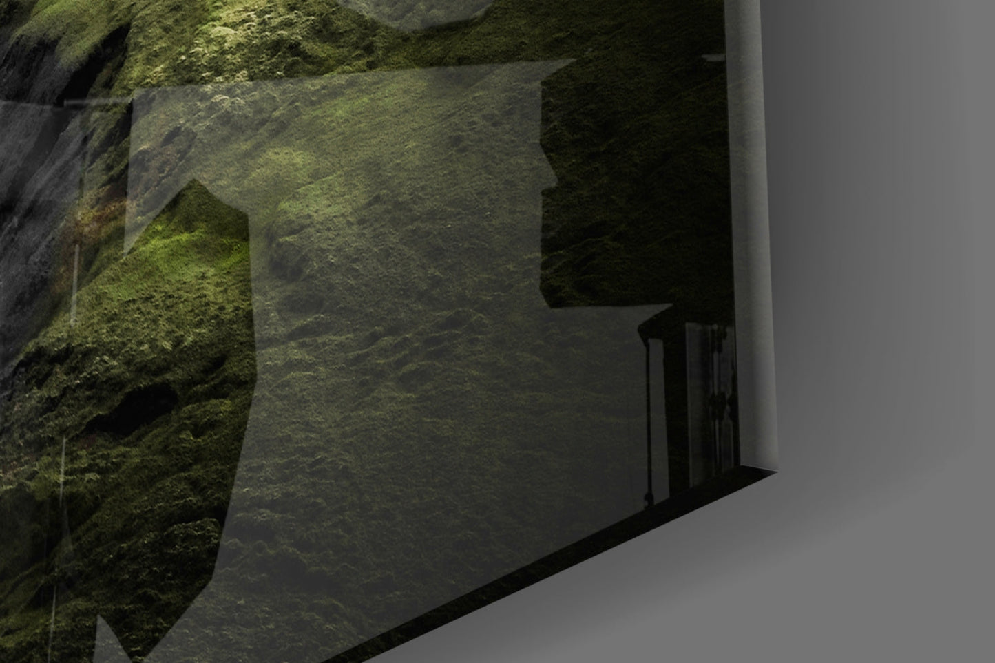 Moss-covered stone wall beside modern white building with black railing detail, angled architectural view.