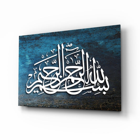 White Arabic calligraphy on textured blue and black glass panel displayed at an angle against white background.